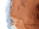a close up of a clay vase with writing on it