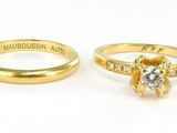 pair of yellow gold wedding rings with a diamond center stone