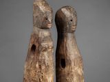 pair of carved wooden figures of a man and a woman