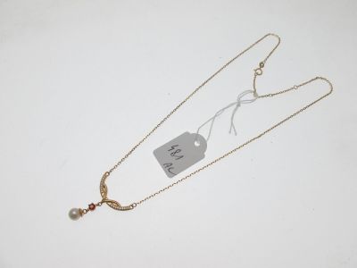 a close up of a necklace with a tag attached to it