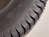 a close up of a tire on a white surface