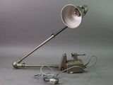 a lamp that is sitting on the ground next to a telephone