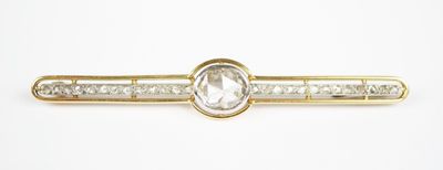 an image of a gold tie bar with a clear stone