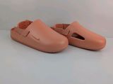 an image of a pair of pink clogs on a white surface