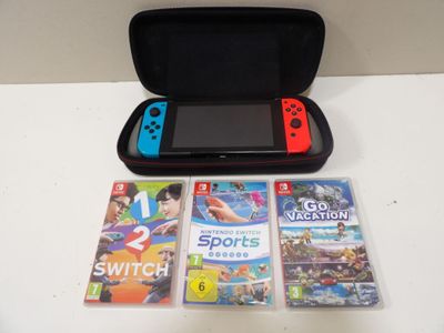 a nintendo wii game system sitting on a table next to a case