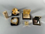 a lot of gold and silver items on a white table