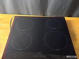 a black and red stove top on a wooden table