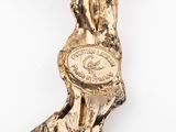 an image of a gold statue of a woman holding a coin