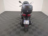 a motorcycle that is parked in a room with a checkered floor