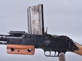 an old gun with a magazine attached to the side of it