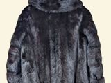 the fur coat is black and has a hood on it