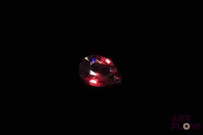 l'image d'un diamant rouge dans l'obscurité, sur fond noir