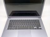 a silver laptop computer sitting on a white surface