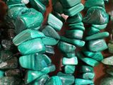 a close up of a bunch of green beads on a table
