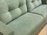 a green couch that is sitting in a room