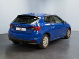 the rear end of a blue car parked in a showroom