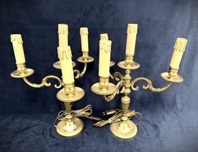 brass candelab with five candles on a blue background