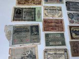 several old german bank notes are displayed on a white surface