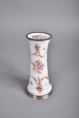 a white vase with a floral design on it