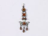 a close up of a pendant with a butterfly on it
