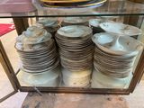 a glass display case with a lot of plates on it