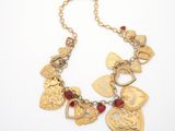 a close up of a necklace on a white surface