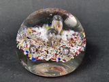 a glass object with a bird in a nest inside of it