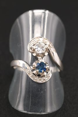 une photo d'une bague sertie d'un saphir bleu et de diamants
