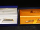 a box with a pen inside of it and a pen in it