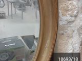 a mirror hanging on the wall next to a table