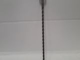 a close up of a drill on a white surface
