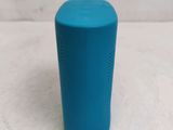 the blue speaker is sitting on top of a white surface