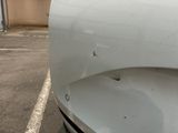 a close up of a car ' s front bumper with a hole in it