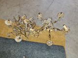 a chandelier that has a bunch of flowers on it