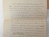 two old papers with writing on them sitting on a table