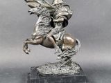statue of a man riding a horse on a marble base