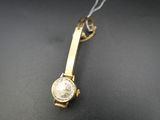 an image of a gold watch with a white face on a black surface
