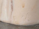 a close up of a marble vase on a table