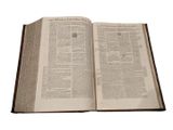 an open book on a table with a white background