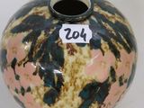 a vase with a tag on it sitting on a table