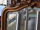 a mirror that is sitting on a table in a room