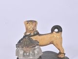 a figurine of a dog with a basket on it