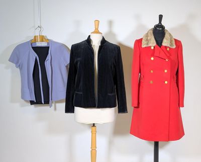 three coats on a mannequin stand in a white room