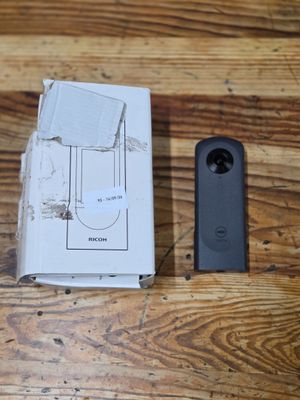 a box and a remote control on a wooden table