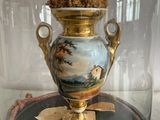 a vase with flowers in it under a glass dome