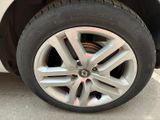 a close up of a tire on a white car