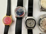 several different types of watches are lined up on a white surface