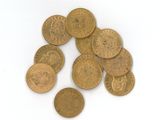 quelques pièces d'or empilées les unes sur les autres sur une surface blanche