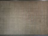 beige and blue striped area rug on a gray floor