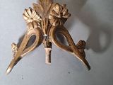 a gold colored metal object with a bird on it